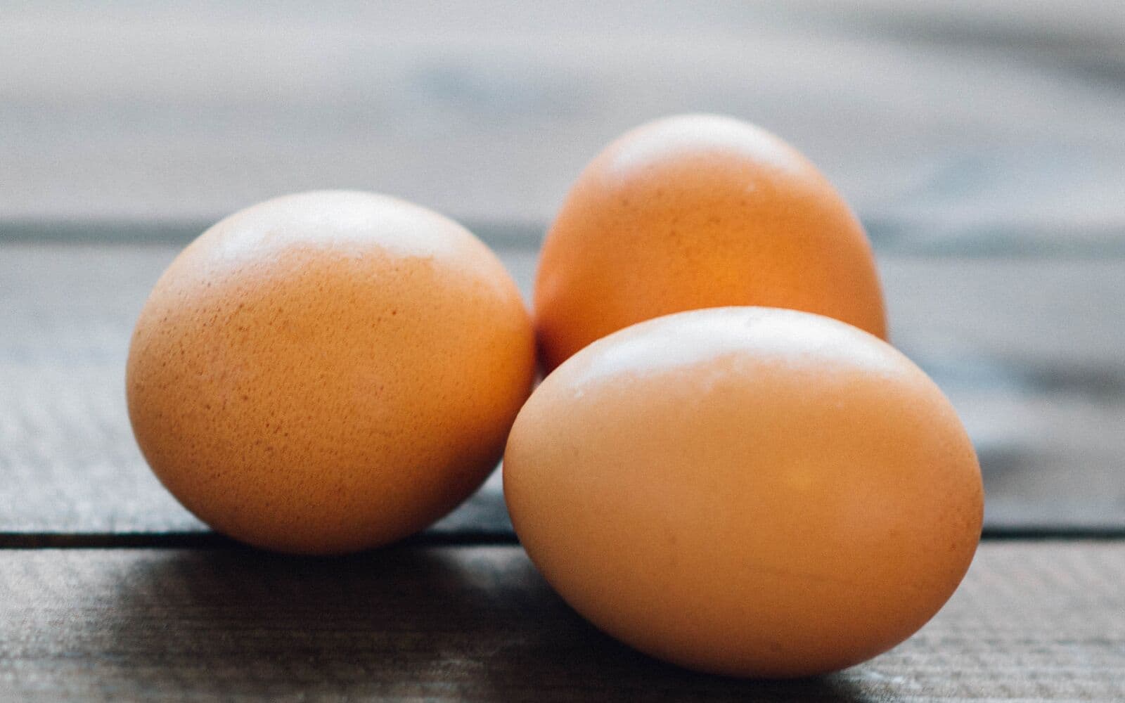 Three eggs lie on a table.